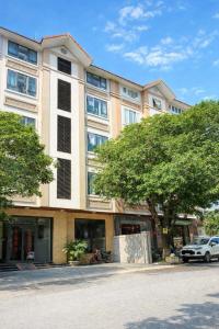 ein großes Gebäude mit einem davor geparkten Auto in der Unterkunft Phương Anh Villa Pro in Bắc Ninh