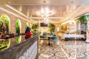 a lobby with a bar with chairs and a table at РИМ Garden in Almaty