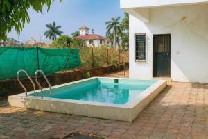 a swimming pool in front of a house at ll MOCKTAIL VILLA ll 3BHK ll AC ll PRIVATE POOL ll MALAVALI ll in Lonavala