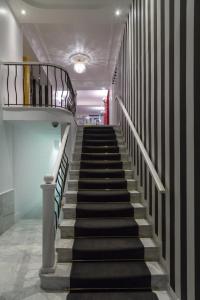 a stairway with black and white stairs in a building at Anaktorikon Boutique Hotel in Tripolis