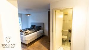 a bedroom with a bed with blue pillows and a bathroom at Castle, Goms in Blitzingen +174 photos