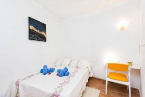 ein Schlafzimmer mit einem Bett mit Spielzeug darauf in der Unterkunft Apartamento Vistas Al Mar y al Teide in Puerto de la Madera