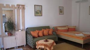 a living room with a couch and a table at Garden City Apartment in Cluj-Napoca
