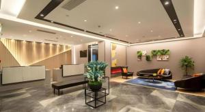 a lobby with chairs and a couch and a table at Home Inn Selected Xiamen University Zhongshan Road in Xiamen