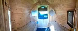 an inside view of a tiny house with a wooden wall at Mini Hotel Übernachten Im Gurkenfass in Lübbenau