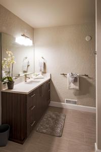 a bathroom with a sink and a mirror at Beach Drive Suites in Seaside