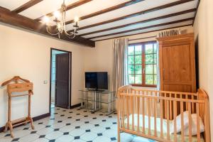 een babykamer met een wieg en een televisie bij L'escapade d'Etretat in La Celle-sous-Gouzon