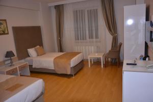 Postel nebo postele na pokoji v ubytování Bilge Suite Hotel