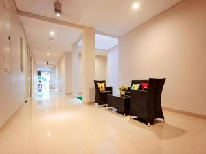a living room with two chairs and a table at Graha Cempaka Boutique Hotel in Surabaya