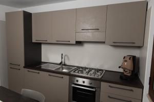 a small kitchen with a stove and a sink at La Casetta di Josh in Marsala