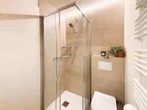 a shower stall in a bathroom with a toilet at Studio in central Crans-Montana in Crans-Montana