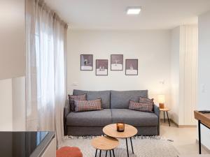 a living room with a couch and a table at Studio in central Crans-Montana in Crans-Montana