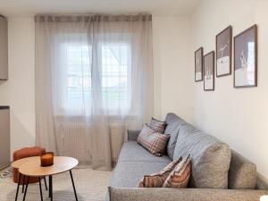 a living room with a couch and a table at Studio in central Crans-Montana in Crans-Montana