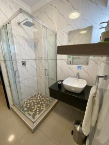 a bathroom with a shower and a sink at Executive Suites and Spa in Letlhakawe +10 photos