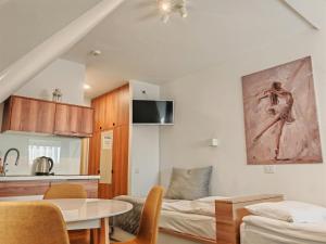 a living room with a bed and a table at Snow White apartments in Kopaonik