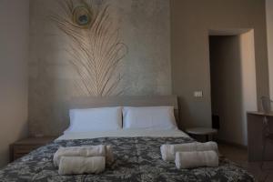 a bedroom with a bed with two pillows on it at La Casetta di Josh in Marsala