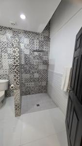 a bathroom with a shower with a tile wall at Luxury Suites Seoul Consulado in Zaragoza +3 photos