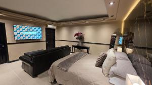 a bedroom with a bed and a flat screen tv at Luxury Suites Seoul Consulado in Zaragoza