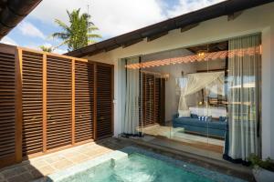 a villa with a pool and a bedroom at Oruva Beachside Villa in Galle