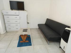 a living room with a couch and a coffee table at Cozy Flat in East London