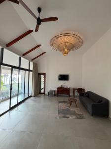 a living room with a ceiling fan and a couch at Shoonya - A Boutique Stay in Varkala +68 photos