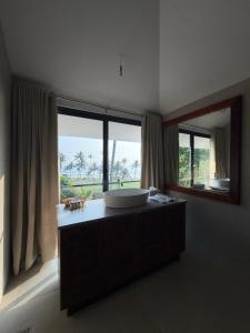 a bathroom with a large sink and a large window at Shoonya - A Boutique Stay in Varkala