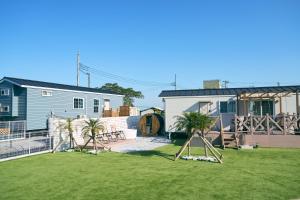 a yard with a house and a playground at Solana木更津 in Kisarazu