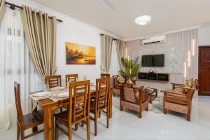 a dining room and living room with a table and chairs at The Islands Breeze Villa in Dehiwala