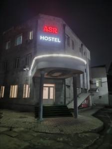 a building with an aeg hospital sign in front of it at ASR HOSTEl in Andizhan