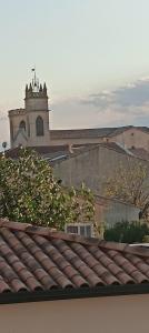 a view from the roof of a building with a clock tower at Studio Emilie in Balaruc-les-Bains