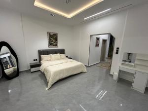 a bedroom with a bed and a mirror in it at قمرة قباء Quba moon1 in Medina