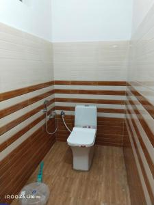 a bathroom with a toilet in a room at Himadri Homestay Sari Devriyatal in Sari