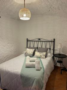 a bedroom with a bed with towels on it at Bike Cueva - Badlands in Gorafe