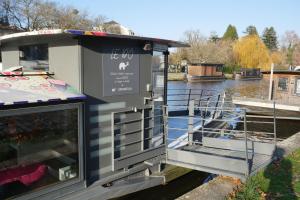 a small boat is docked on a river at Péniche ! Amours Le Dô Karina Bisch 2019 in Nantes +5 photos