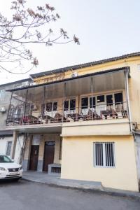 a building with a balcony with chairs on it at MBM Hotel in Yerevan