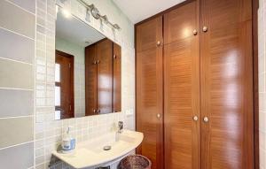 a bathroom with a sink and a mirror at Dúplex Fornells Carme 3 in Fornells