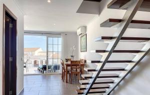 a staircase in a house with a dining room at Dúplex Fornells Carme 3 in Fornells +51 photos
