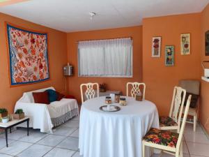 a room with a table and chairs and a bed at Aquarela Suítes in Piúma