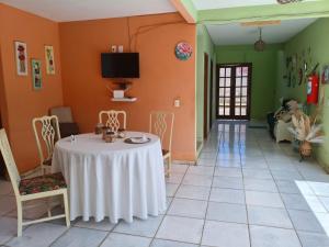 a dining room with a table and chairs at Aquarela Suítes in Piúma +48 photos