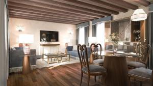 a living room with a table and chairs and a fireplace at Gabrielli Luxury Apartments Venezia - Starhotels Collezione in Venice