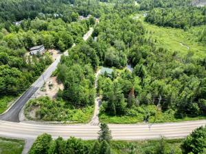 an aerial view of a road in a forest at Spa et Waterfront - Cachette du Petit Lac in Chertsey