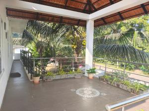 a porch with potted plants on a house at Coorg Ashiyana in Kushālnagar