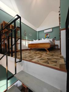 a bedroom with a bed and a staircase in it at Namphung Phuket Boutique Resort in Rawai Beach +126 photos