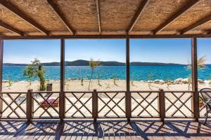 a view of the beach from the porch of a beach house at Sibenik Resort in Šibenik