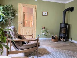 a living room with a chair and a wood stove at Ferienhaus Glockenklang in Sangerhausen