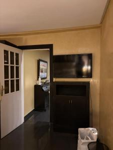 a living room with a flat screen tv on the wall at Welcome to your Stylish apartment in Oulad Akkou