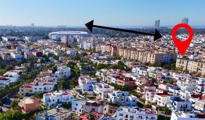 an aerial view of a city with a red marker at Welcome to your Stylish apartment in Oulad Akkou