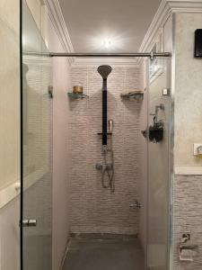 a shower with a glass door in a bathroom at Welcome to your Stylish apartment in Oulad Akkou +14 photos