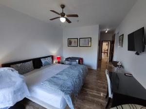 a bedroom with a bed and a ceiling fan at Seule résidence accès directe plage in Saïdia +74 photos