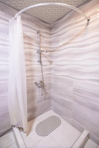 a bathroom with a shower with a shower curtain at MBM Hotel in Yerevan
